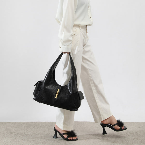 Slouchy leather-look hobo shoulder bag with gold-tone bar clasp and crinkled glossy finish, detail view 7