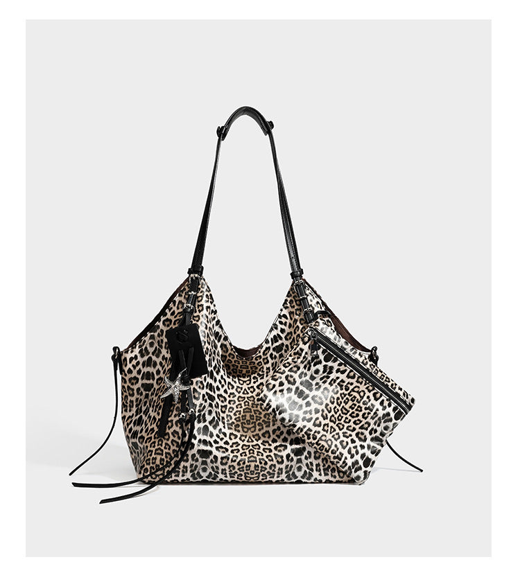 Large leopard print shoulder tote bag with glossy finish, long double straps, front zip pocket, silver-tone hardware, and