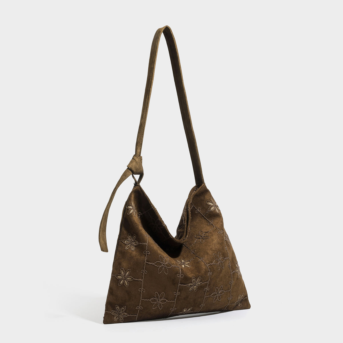 Lässig weich fallende Hobo-Schultertasche in dunkelbrauner Velourslederoptik mit Ton-in-Ton-Blumenstickerei und langem, geknotetem Einzelriemen, Detailansicht