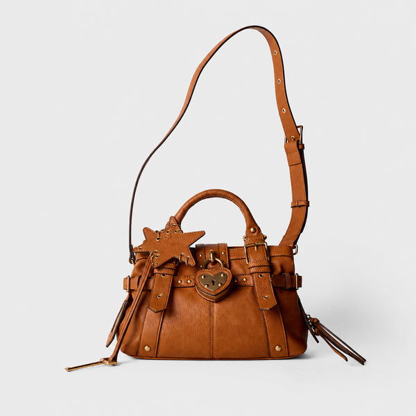 Structured satchel bag with heart-shaped padlock hardware, rivet studs, star charm, and twin top handles, detail view 4
