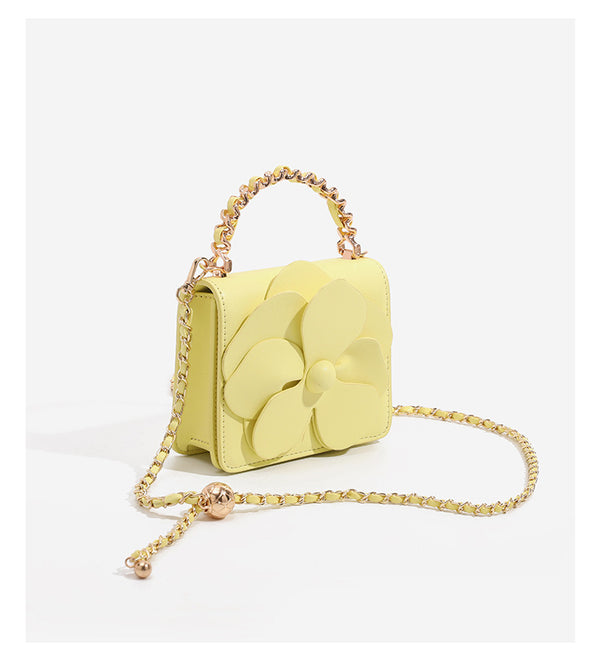 Small structured rectangular crossbody bag with layered 3D flower appliqué and gold-tone chain strap, detail view 10