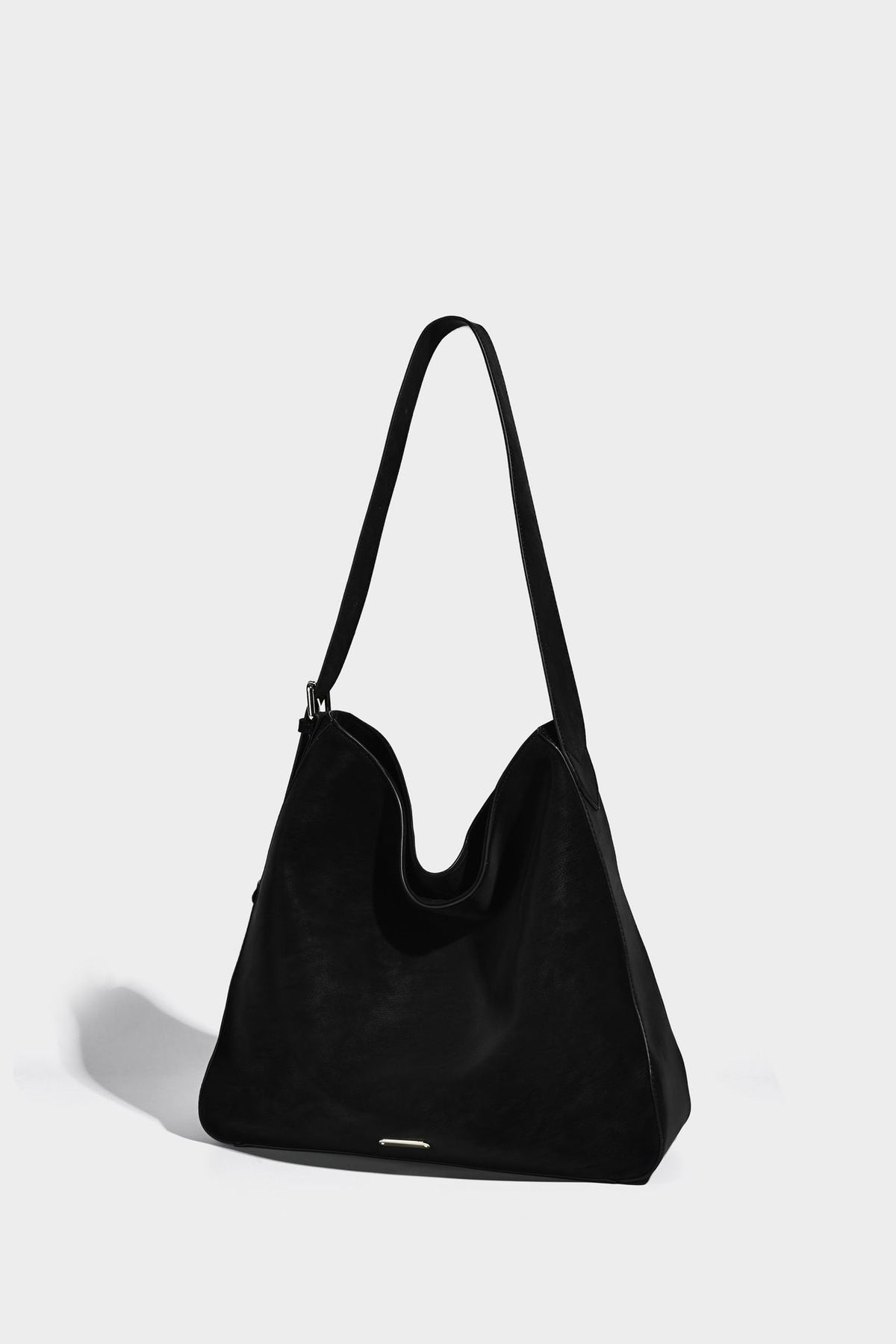 Large slouchy hobo shoulder bag in matte leather-look finish with adjustable strap and gold-tone bar hardware, detail view 16