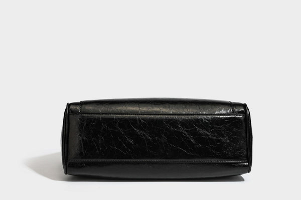 Structured glossy crinkled leather-look satchel with double top handles, front metal-plaque tab, silver-tone hardware, and