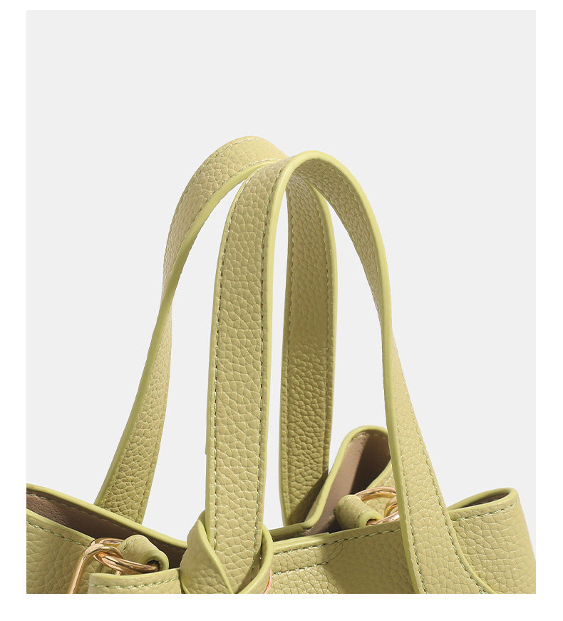 Pebbled leather-look bucket tote with elephant charm pendant, dual top handles, and detachable shoulder strap, detail view 15