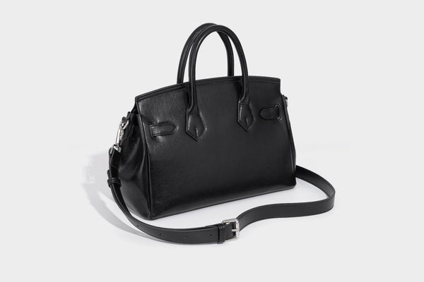 Structured black leather-look satchel bag with silver padlock hardware, front zip pockets, key charms, and top handles
