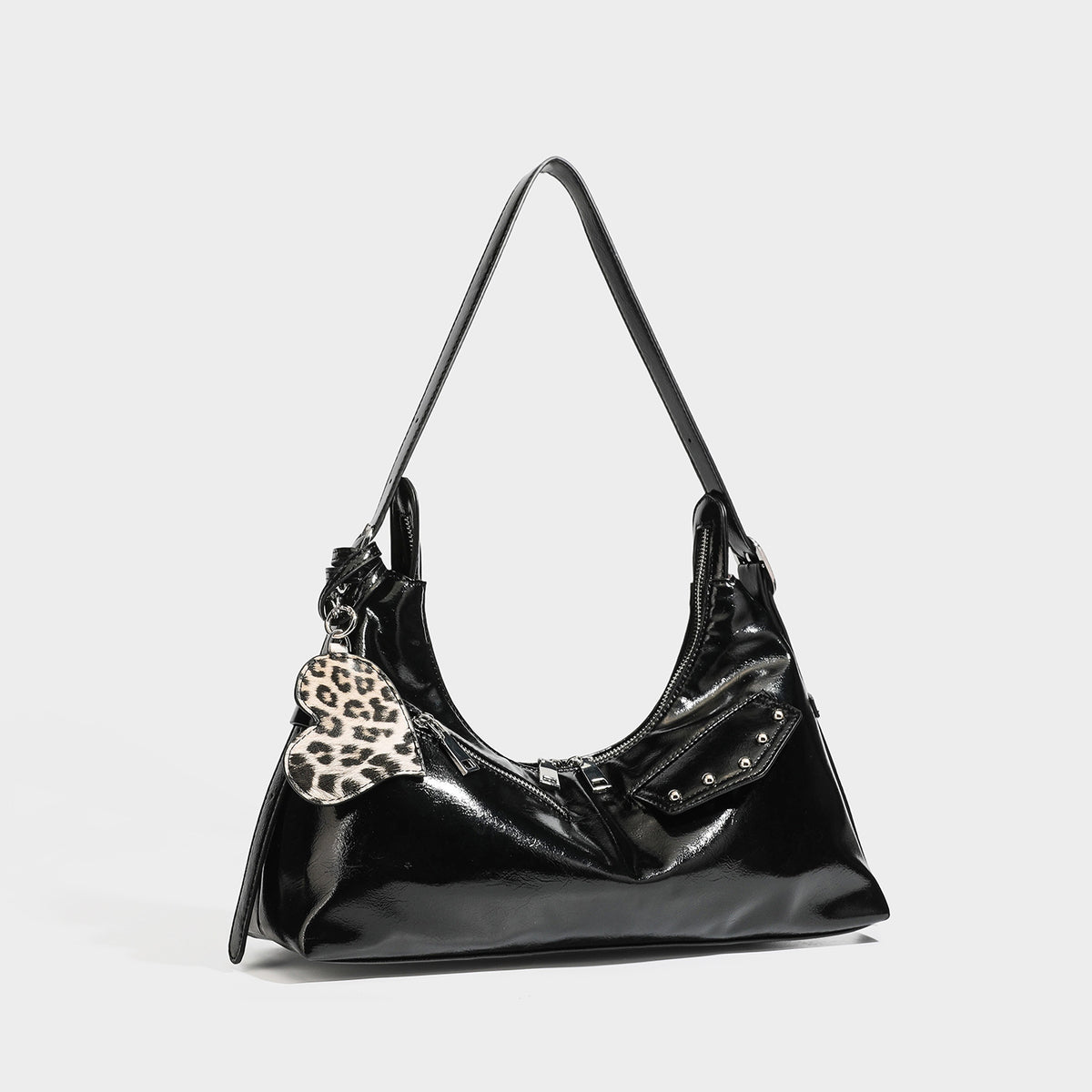 Glossy dark brown hobo shoulder bag with slim strap, front zip pocket, stud detail, and detachable leopard-print heart charm