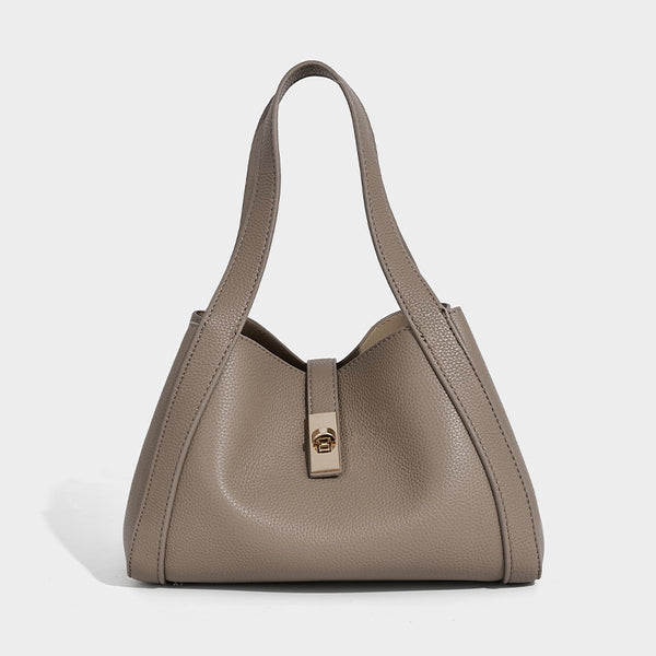 Structured trapezoid tote bag in taupe pebbled leather-look finish with gold-tone turn-lock hardware, dual top handles, and