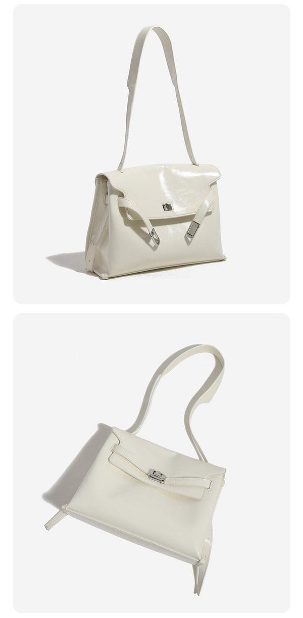 Structured rectangular flap shoulder bag in glossy leather-look finish with silver-tone turn-lock closure and adjustable
