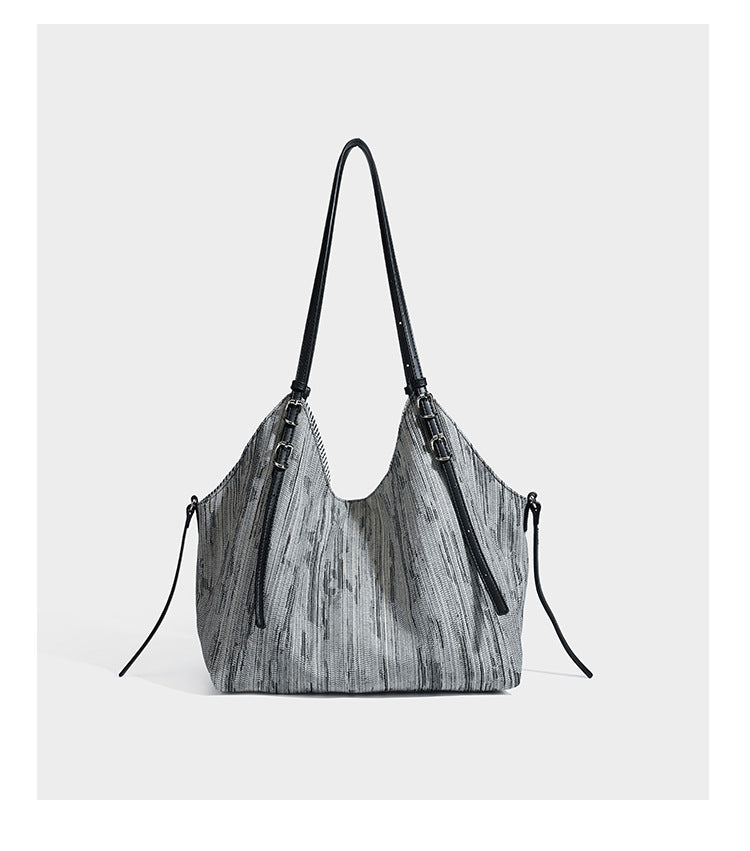 Large slouchy woven-texture shoulder tote bag with slim leather-look straps, side cinch ties, and silver-tone hardware
