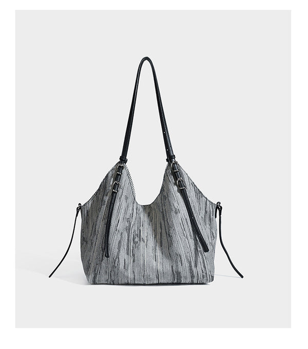 Large slouchy woven-texture shoulder tote bag with slim leather-look straps, side cinch ties, and silver-tone hardware