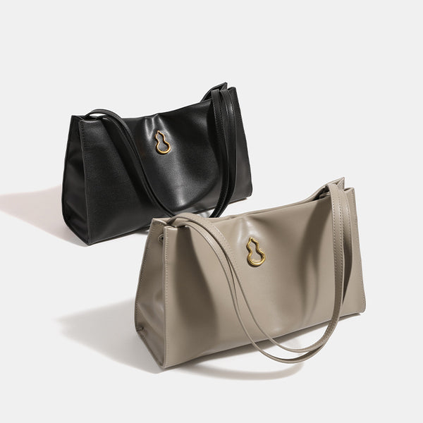 Smooth leather-look slouchy trapezoid shoulder tote with gold-tone gourd clasp hardware and long slim straps, front view