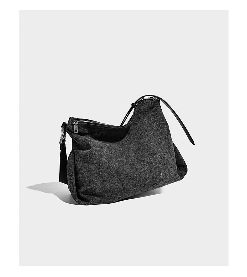 Charcoal denim-textured slouchy hobo bag with zip-top closure, silver-tone hardware, and adjustable leather-look crossbody