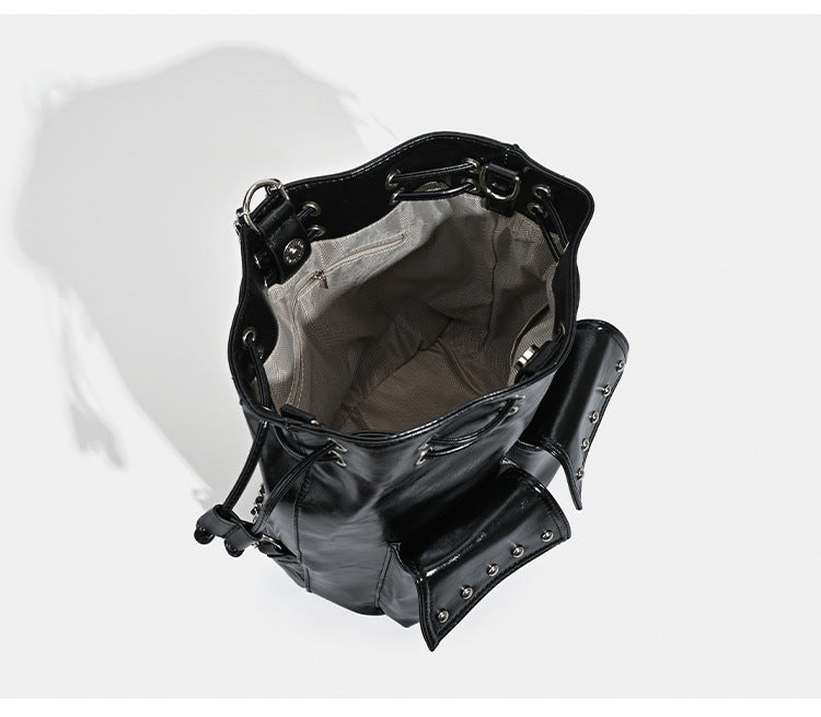 Glossy leather-look drawstring bucket bag with silver dome studs and chain shoulder strap, detail view 8