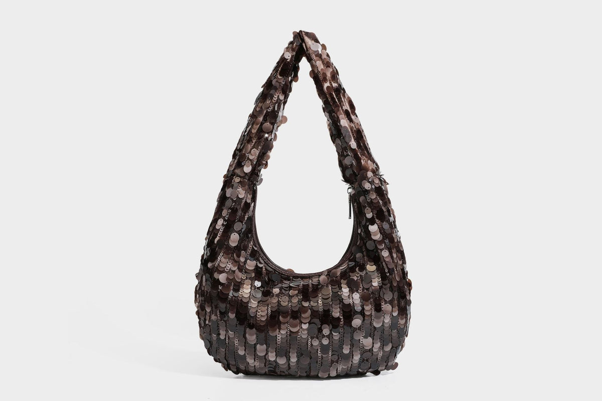 Slouchy crescent hobo shoulder bag covered in overlapping reflective sequin discs with a single integrated strap and top-zip