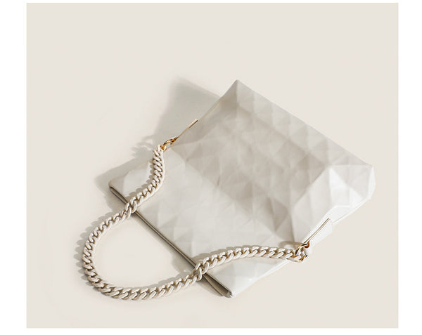 Cream white rectangular flap shoulder bag with geometric faceted surface and chunky tone-on-tone chain strap with gold-tone