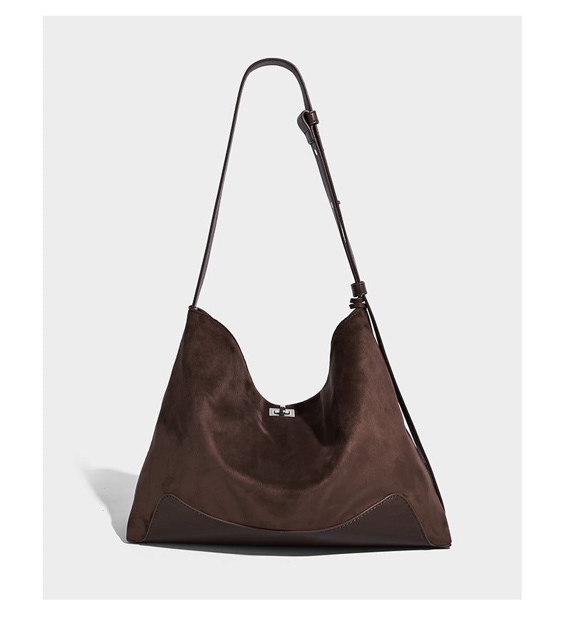 Dark brown slouchy hobo bag with matte suede-look body, smooth leather-look base trim, adjustable shoulder strap, and, detail