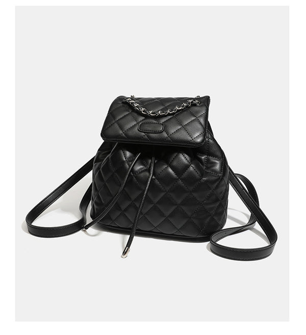 Black diamond-quilted backpack handbag with silver-tone chain flap accent and adjustable shoulder straps, detail view 12