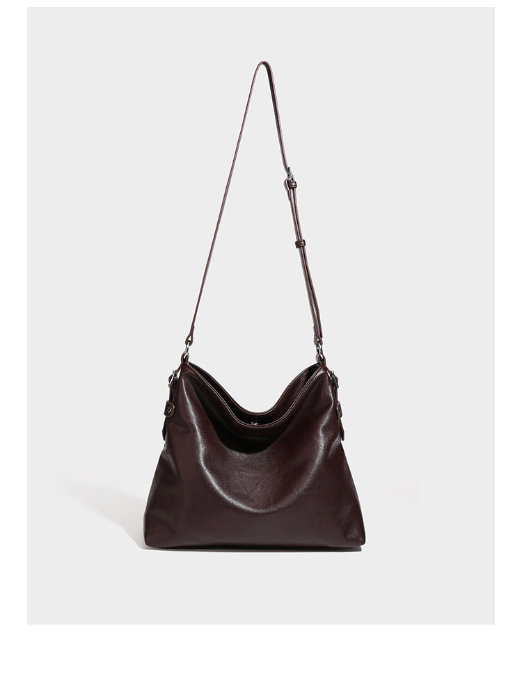 Large slouchy hobo shoulder bag in dark brown with smooth leather-look finish, adjustable strap, and silver-tone hardware