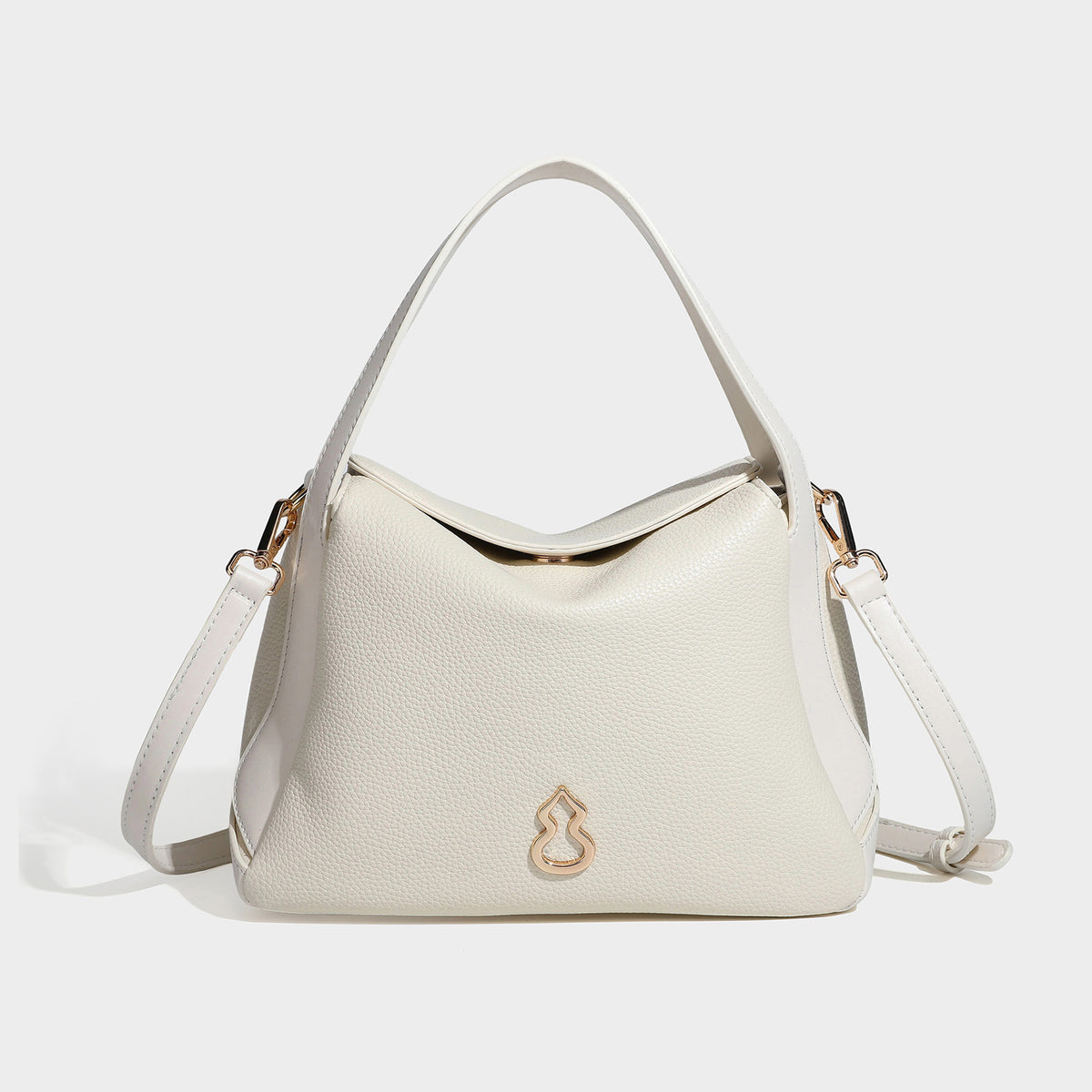 Structured pebbled leather-look shoulder bag with flap top, gold-tone emblem hardware, dual top handles, and detachable