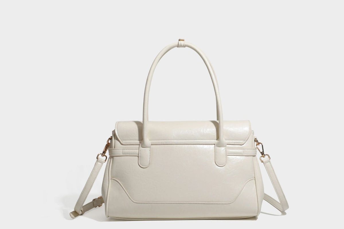 Structured glossy leather-look satchel bag with flap closure, gold-tone buckle accents, double top handles, detachable