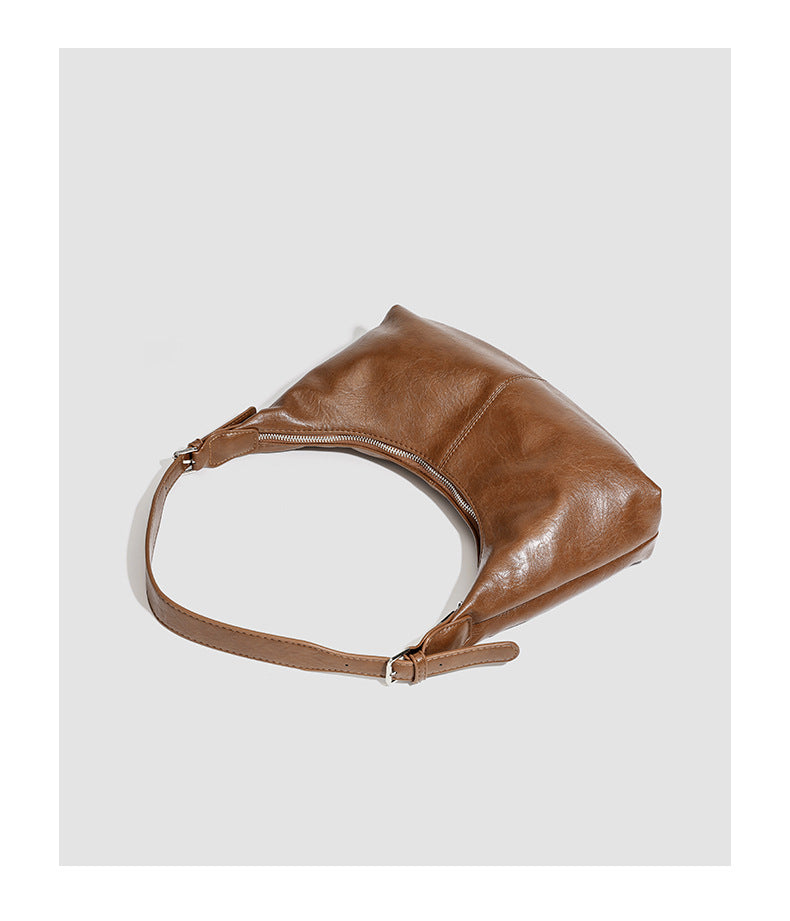 Slouchy crescent hobo shoulder bag with zip-top closure and adjustable strap, detail view 11