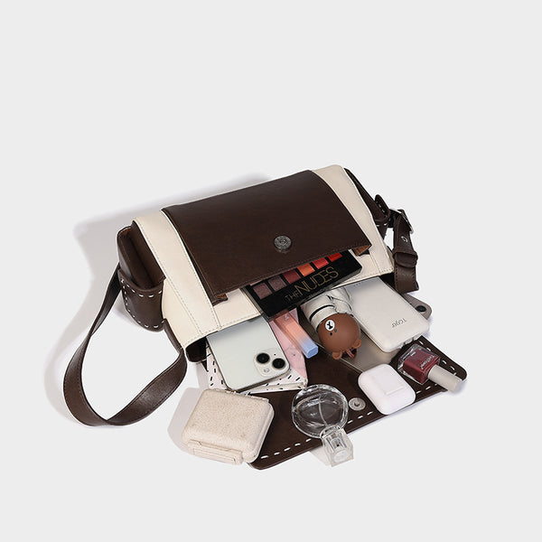 Structured flap crossbody bag in dark brown and cream color-block with white contrast stitching, adjustable shoulder strap