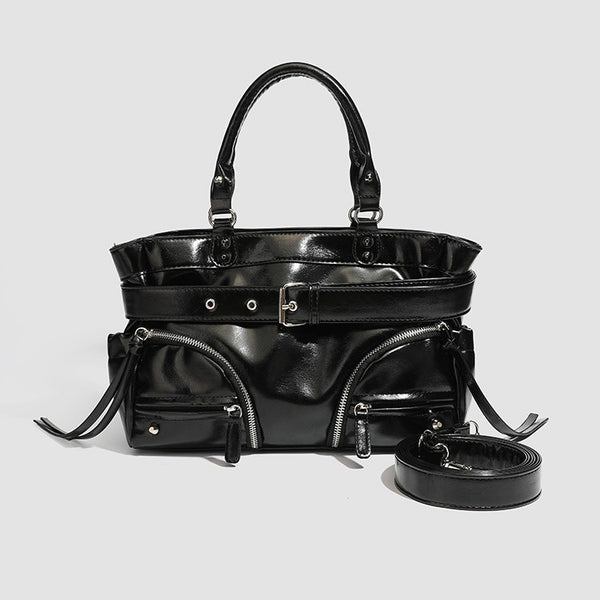 Black glossy structured tote bag with rivet and buckle detail, dual top handles, and detachable shoulder strap, front view