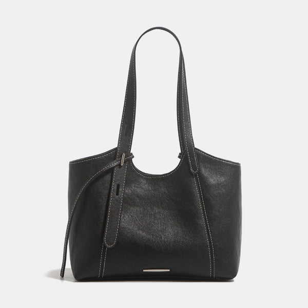Structured leather-look tote shoulder bag with double crossed straps, contrast topstitching, and metal bar hardware, detail