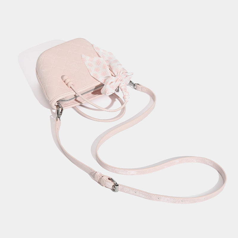 Quilted leather-look mini tote bag with printed scarf bow on braided top handle and silver-tone hardware, detail view 4