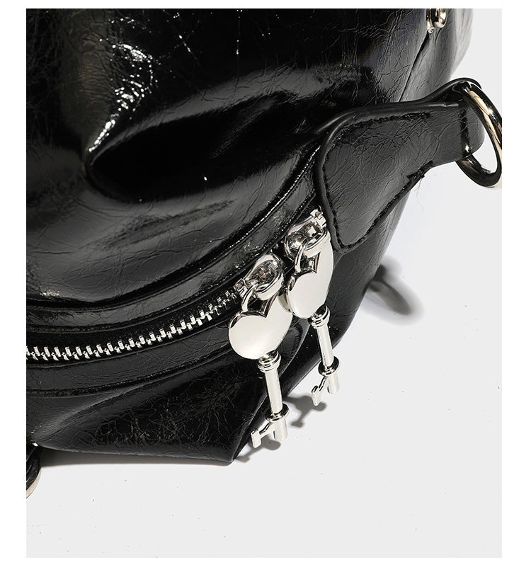 Glossy crinkled barrel handbag with silver stud buckle strap and detachable shoulder strap, detail view 18