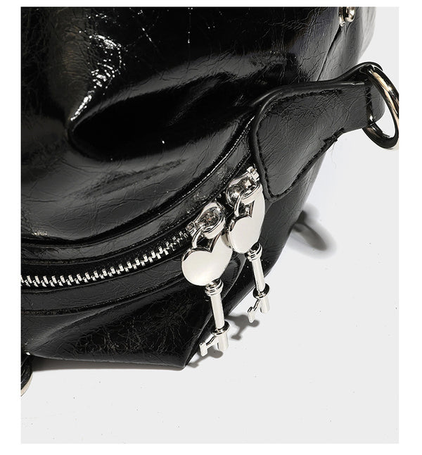 Glossy crinkled barrel handbag with silver stud buckle strap and detachable shoulder strap, detail view 18