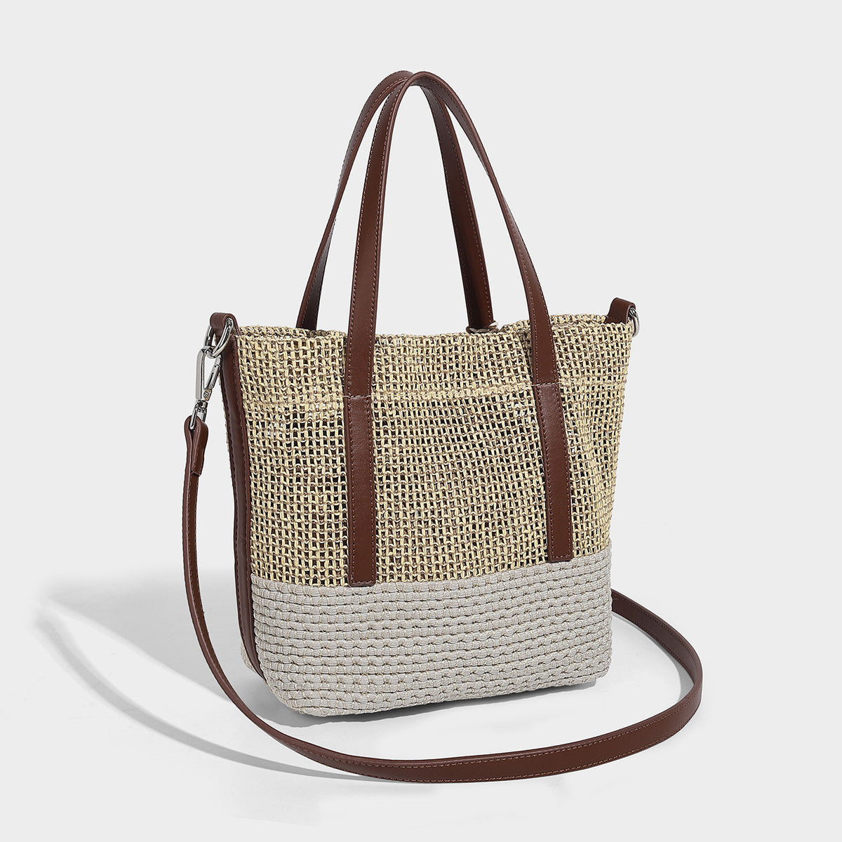 Two-tone open-weave tote bag in beige and cream with brown leather-look handles, tassel bead charm, and detachable