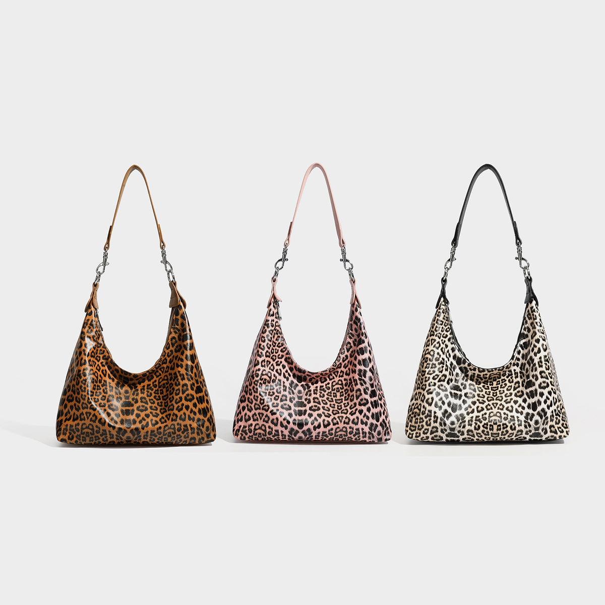 Slouchy hobo shoulder bag in glossy leopard-print leather-look finish with zip-top closure and silver-tone clip hardware