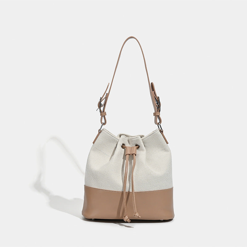 Beigefarbene Bucket-Bag aus Canvas mit Kordelzug, kontrastierendem Unterteil in Lederoptik und verstellbarem Schulterriemen, Detailansicht 7