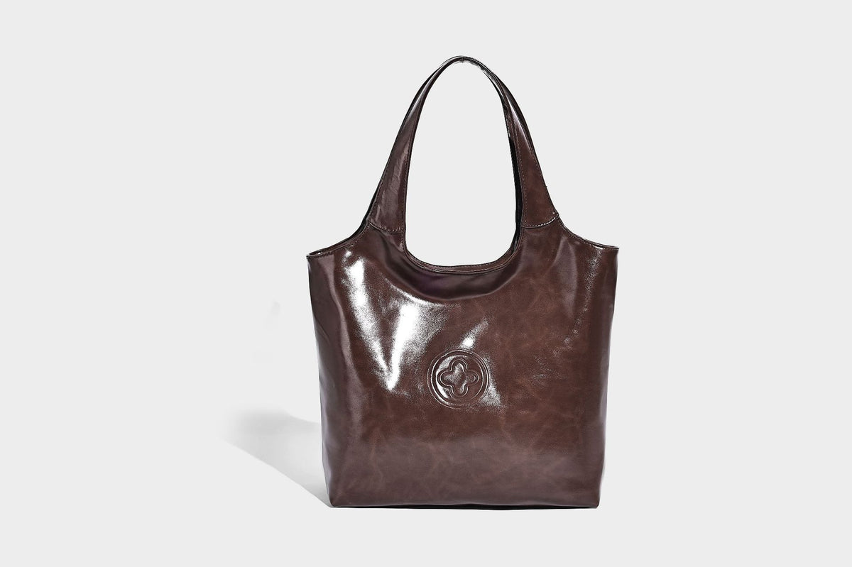 Glossy oil-wax leather-look open-top tote shoulder bag with embossed circular logo and long double straps, detail view 21