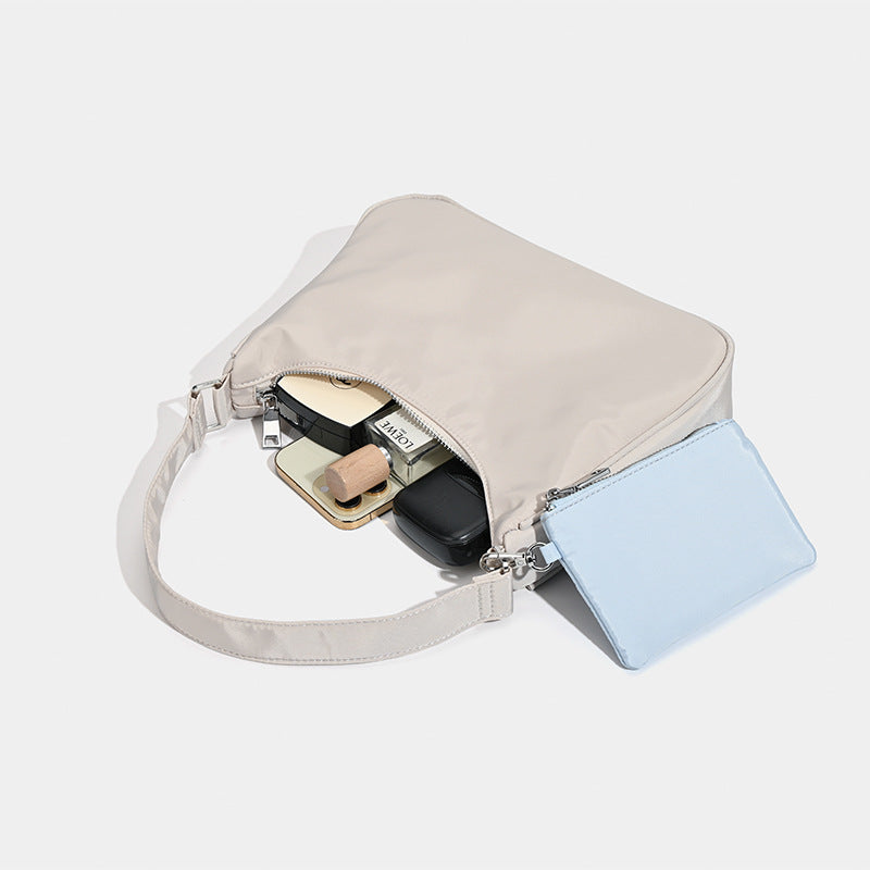 Curved hobo shoulder bag with detachable zip pouch in matte-satin finish with silver-tone hardware, detail view 4