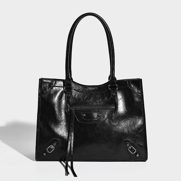 Large structured leather-look tote bag with front zip pocket, moto hardware accents, and long double shoulder straps, detail