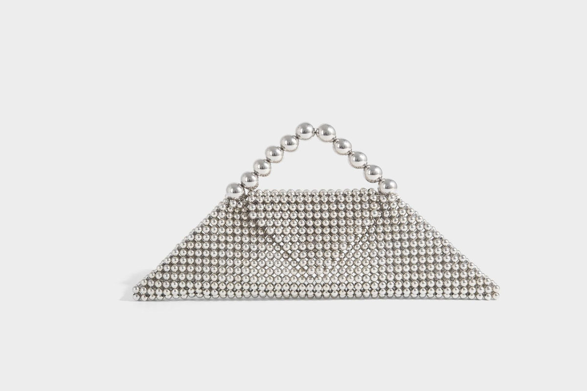 Small structured triangle clutch bag covered in glossy pearl beads with an arched pearl top handle and silver snap closure