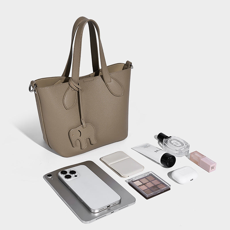 Compact pebbled bucket tote bag with elephant charm, twin top handles, and detachable crossbody strap, detail view 4