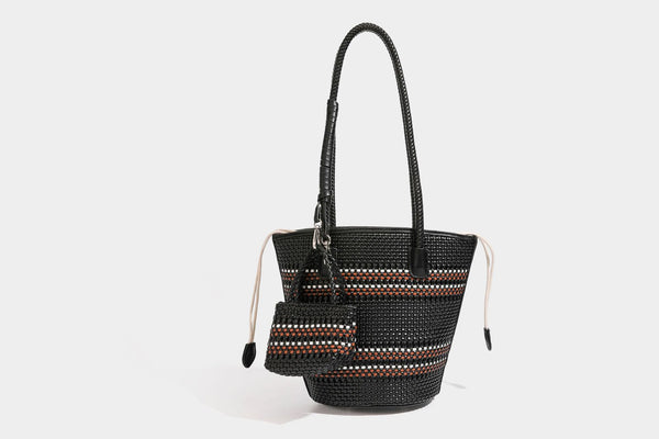 Light blue open-weave woven bucket tote bag with long braided shoulder straps, drawstring side ties, and attached mini pouch