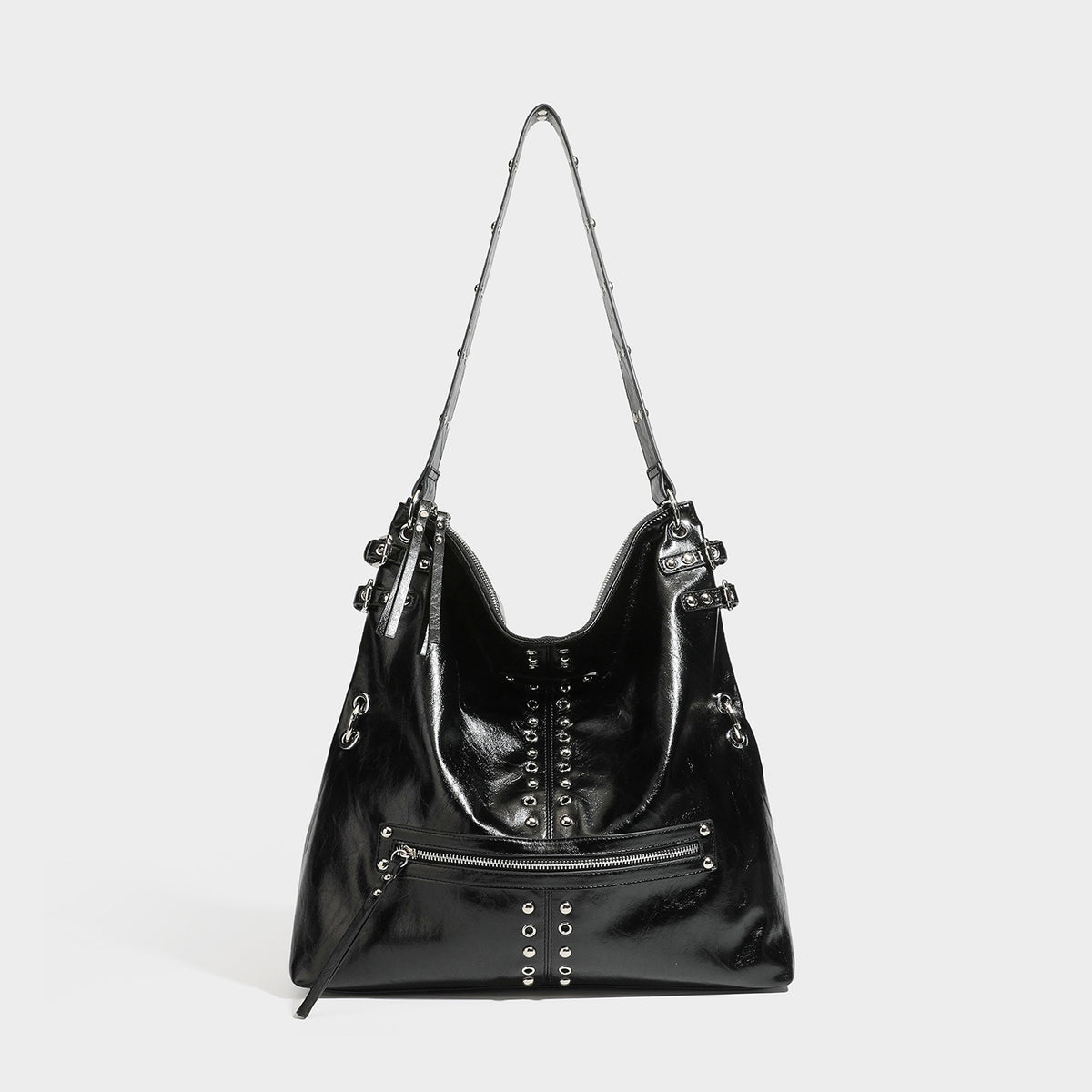 Black glossy leather-look slouchy shoulder bag with silver stud and eyelet hardware, top zip closure, front zip pocket, and