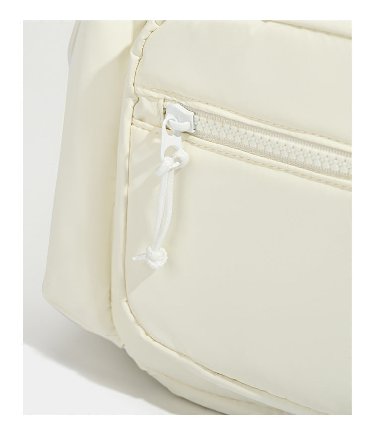 Soft matte nylon flap backpack with front zip pocket and side drawcord pockets, detail view 14