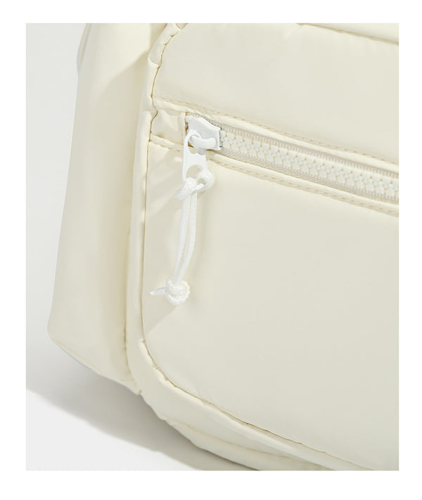 Soft matte nylon flap backpack with front zip pocket and side drawcord pockets, detail view 14