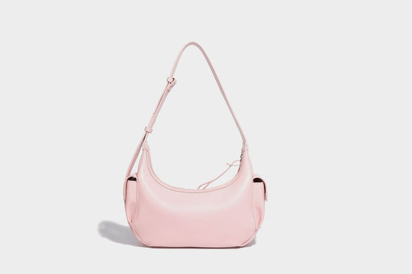 Smooth leather-look crescent shoulder bag with front zip pocket, side flap pockets, adjustable strap, and silver-tone, detail
