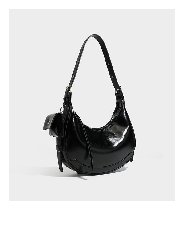 Glossy leather-look crescent hobo shoulder bag with dark contrast trim, silver-tone hardware, and attached mini flap pouch