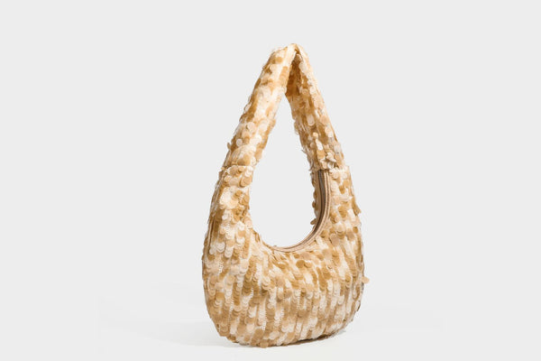 Slouchy crescent hobo shoulder bag covered in overlapping reflective sequin discs with a single integrated strap and top-zip