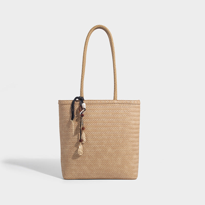 Structured woven herringbone tote bag with braided double shoulder handles in tan brown, shown with matching drawstring
