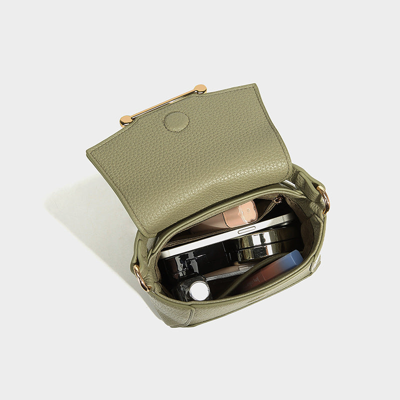 Small structured pebbled flap mini satchel with gold-tone bar hardware, short top handle, and detachable crossbody strap