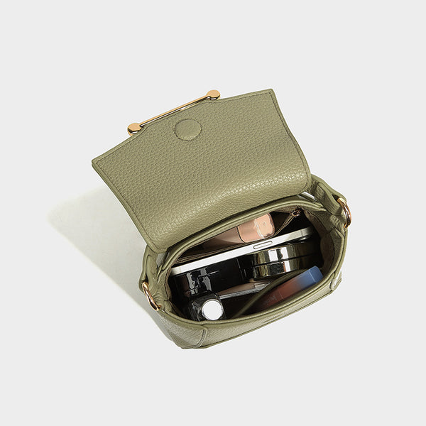 Small structured pebbled flap mini satchel with gold-tone bar hardware, short top handle, and detachable crossbody strap