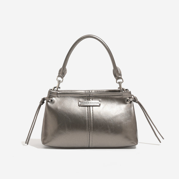 Small retro convertible shoulder bag with glossy leather-look finish, side drawstring ties, top zip closure, and silver-tone